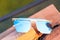 Oversized sunglasses model with blue lenses closeup . Selective focus