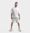 Oversized white t-shirt template, shorts on posing bearded guy in sneakers, front view, isolated on background