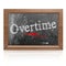 Overtime text written on blackboard