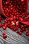 An overturned basket of cranberries. The berries were scattered over the surface of the planks with a wooden structure