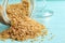 Overturned bowl of brown sugar on blue wooden table, closeup