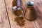 Overturned cezve with coffee beans, bowl with ground coffee on wooden table