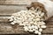 Overturned sack with white beans on wooden table, closeup