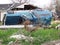 Overturned truck wreckage in front of damaged house, after Hurricane Katrina