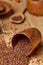 An overturned wooden bowl with linseeds on a rustic background, close-up, shallow depth of field, selective focus