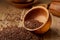 An overturned wooden bowl with linseeds on a rustic background, close-up, shallow depth of field, selective focus