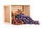 Overturned wooden crate with ripe sweet grapes on white background