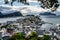 Overview of Alesund town from the Aksla viewpoint during the late evening before sunset with tree leaves framing