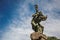 Overview of bronze sculpture with blue and sunny sky. In a square at Orvieto.