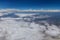 Overview in desert Arizona from the plane of fluffy clouds in mountains an airplane