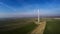 Overview of a lonely windturbine in green meadow Poland