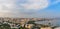 Overview panorama of central city business district at the bay with marina and residential suburbs in sunset rays, Baku,