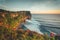 Overview panorama ocean shore, cliff. Sunset. Bali