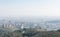 Overview of the polluted city of Barcelona, from the Collserola mountain, with a layer of smog over it