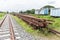 Overview of a railroad track and piles of cross ties lying