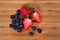 Overview red sweet strawberries blueberries on a bamboo cutting board
