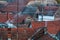 Overview of tile rooftops of old houses. Old buildings architecture