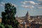 Overview of trees, cathedrals domes and buildings roofs in the sunset of Rome.