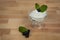 Overview of white greek yogurt in glass cup blueberries and green mint leafs