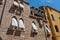 Overview of windows in old brick building with fabric blinds in Venice.