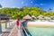 Overwater bungalow hotel resort in Tahiti, Moorea island. Person on holiday relaxing at French polynesia luxury