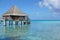 Overwater bungalow with thatched roof in lagoon