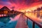 overwater bungalows at sunset with vibrant sky