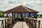 Overwater wooden gazebo on lake. Distance perspective