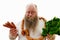 An overweigh man choosing what is better for health :Sausages or Greens. Bearded obese man with a bruch of sausages around the