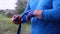 Overweight adult man in blue sportswear rewinds his hand with a blue textile bandage for sports and boxing