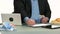 Overweight businessman eating fast food at office.