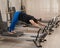 Overweight caucasian woman doing pilates exercises on a reformer.