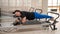 Overweight caucasian woman doing pilates exercises on a reformer.