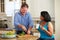 Overweight Couple On Diet Preparing Vegetables In Kitchen