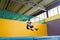 Overweight cute little boy jumping on trampoline indoors in a sport center for kids