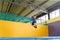 Overweight cute little boy jumping on trampoline indoors in a sport center for kids