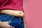 Overweight fat woman isolated on a pink background in Studio, closeup. Weight losing, obesity, .cellulite, health care concept