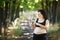 Overweight fat woman pointing on a bottle of water in her hand.