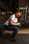 Overweight girl squatting with weight disc in gym