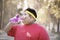 Overweight man drinking water after exercises