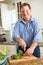 Overweight Man Preparing Vegetables in Kitchen