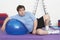 Overweight Man Resting On Exercise Ball