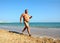 Overweight man running on beach