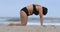 Overweight Mature caucasian woman doing exercise on yoga mat on beach, female lbends her back. Concept of healthy