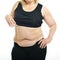 Overweight middle-aged woman shows belly fat, isolated over white background. Overeating xxl size girl