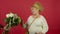 Overweight senior woman with handbag refusing flowers