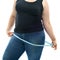 Overweight unhappy young woman measuring her hips,  over white background. Overeating xxl size woman