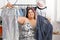 Overweight woman choosing clothes in shop