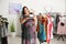 Overweight woman choosing hat in shop