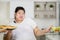 Overweight woman choosing pizza and refuse salad